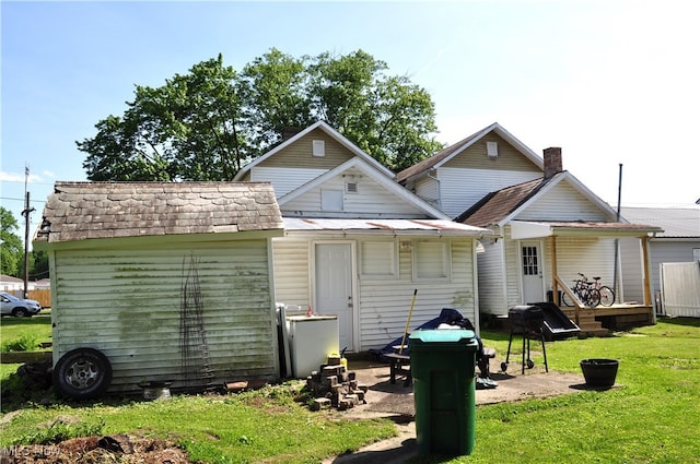 back of property featuring a yard