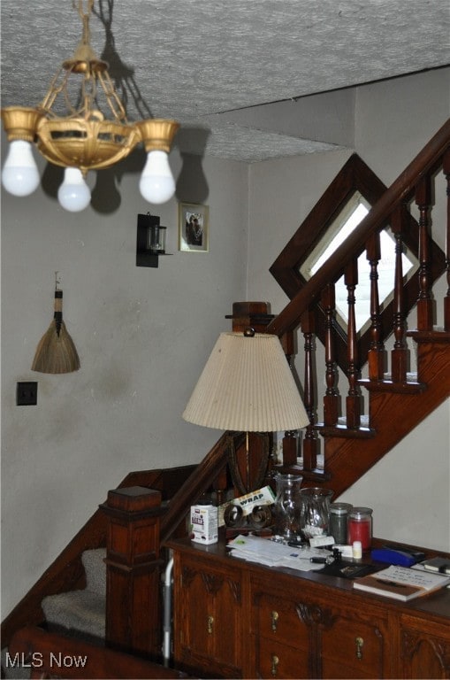 stairs featuring a textured ceiling