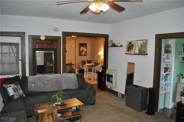 living room featuring carpet flooring, a textured ceiling, heating unit, and ceiling fan