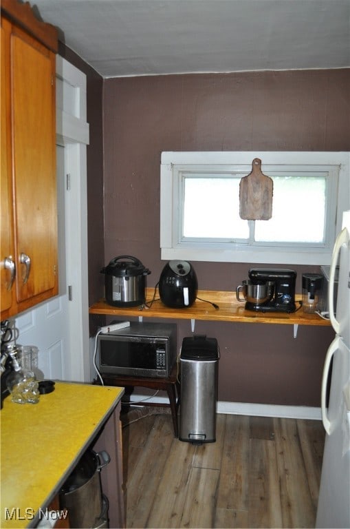 kitchen with dark hardwood / wood-style floors and white refrigerator