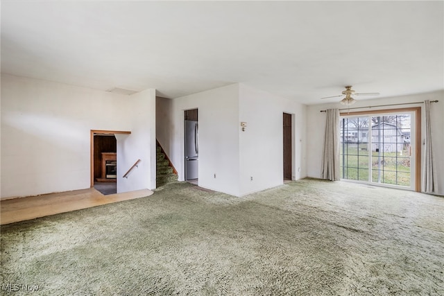 carpeted spare room featuring ceiling fan