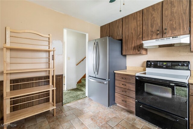 kitchen with electric range and stainless steel refrigerator