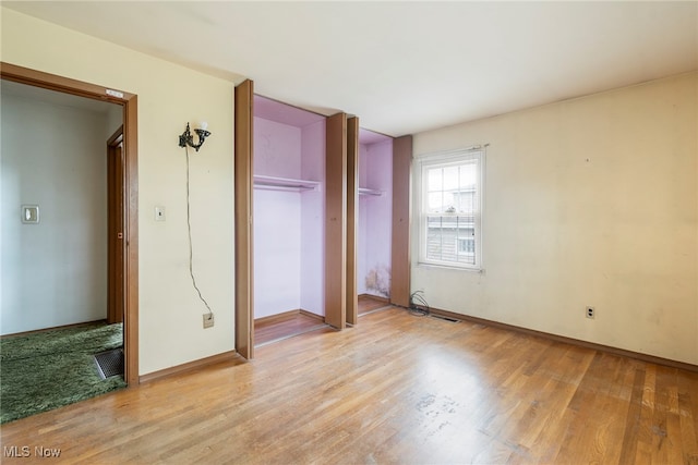 unfurnished bedroom featuring a closet and light hardwood / wood-style flooring