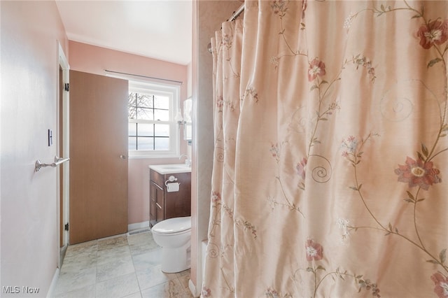 bathroom featuring tile patterned floors, vanity, and toilet