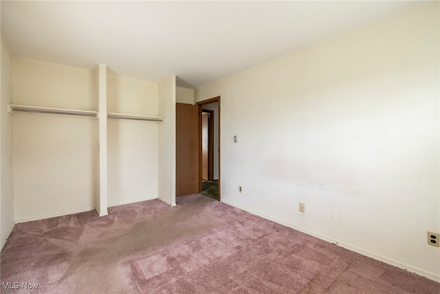 unfurnished bedroom featuring carpet floors and a closet