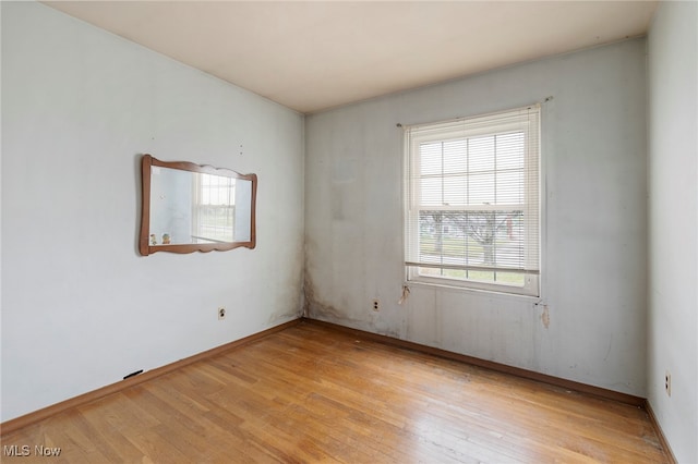 empty room with light hardwood / wood-style flooring