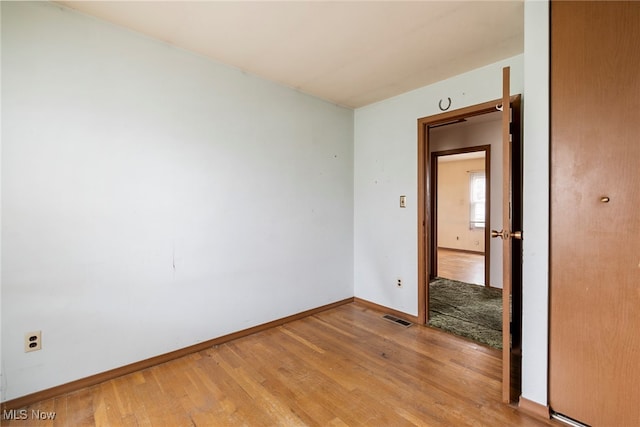 empty room with light hardwood / wood-style floors