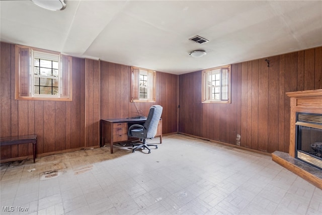 office featuring wood walls and plenty of natural light