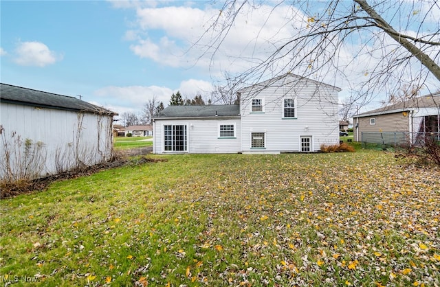 rear view of house with a yard