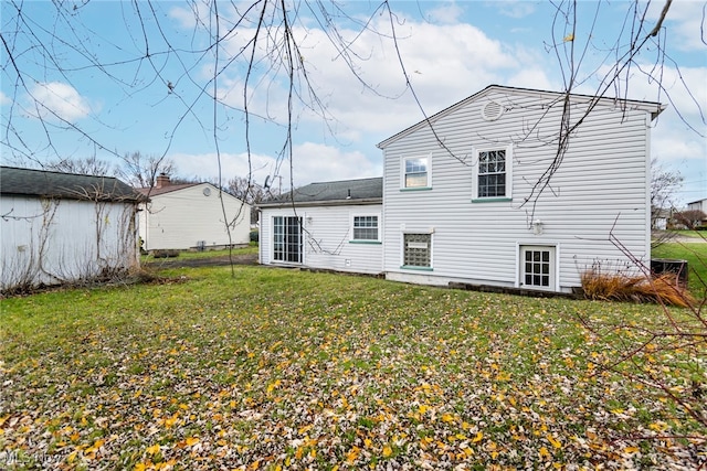 rear view of property with a lawn