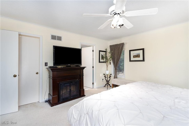 bedroom with ceiling fan and light colored carpet