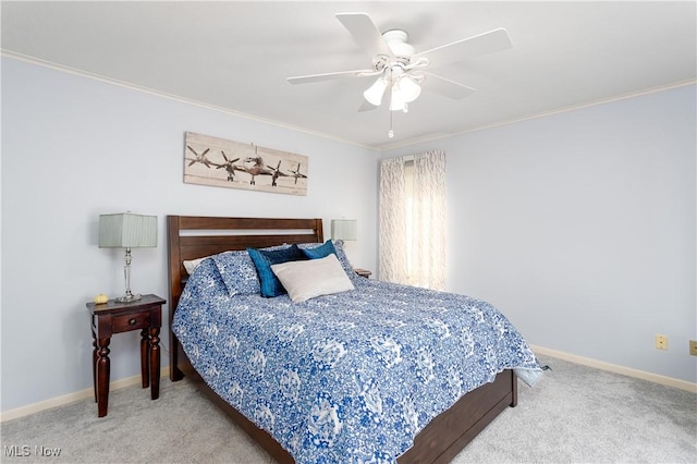 carpeted bedroom with ceiling fan and ornamental molding