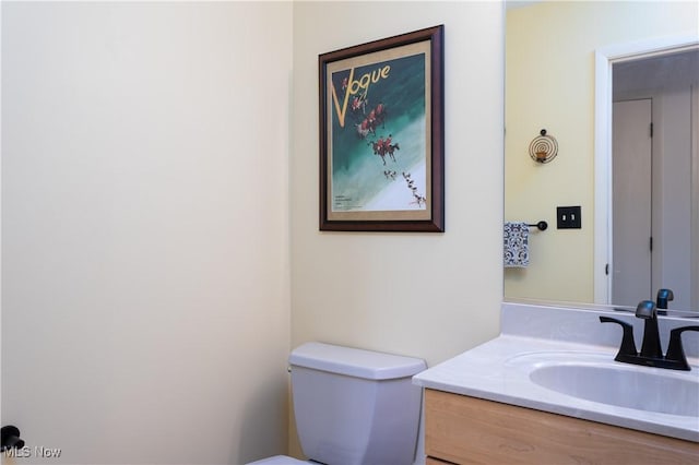 bathroom featuring vanity and toilet