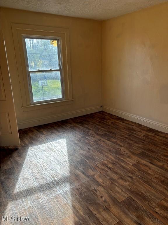 1013 Saint George, East Liverpool, OH 43920 - empty room featuring dark wood finished floors and a textured ceiling
