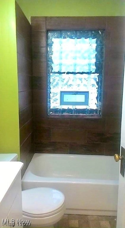 full bathroom with vanity, toilet, and tiled shower / bath combo