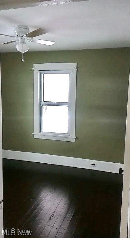 empty room with ceiling fan and wood-type flooring