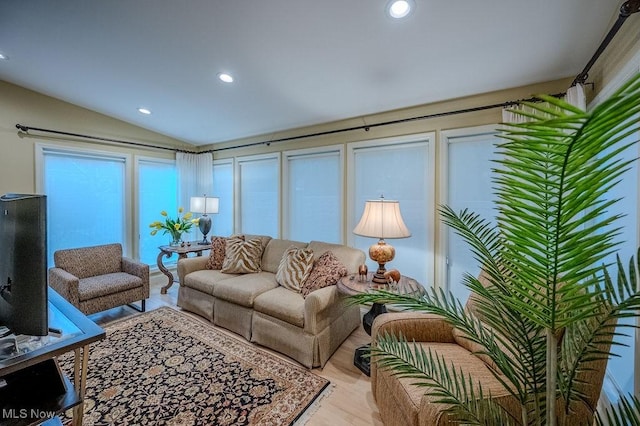 living area with vaulted ceiling, wood finished floors, and recessed lighting