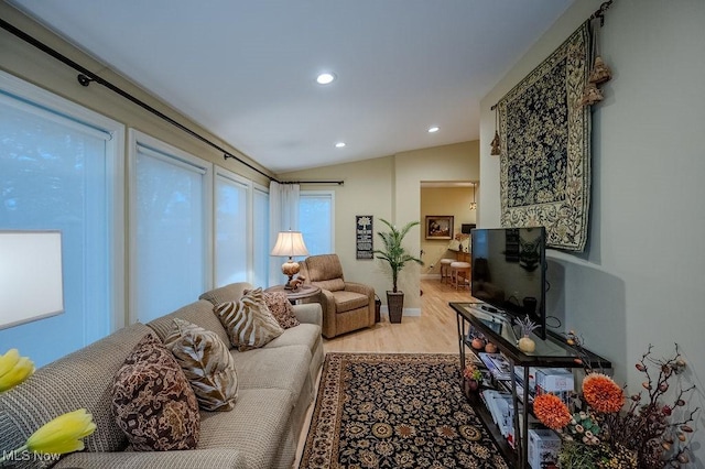 living area featuring lofted ceiling, wood finished floors, and recessed lighting