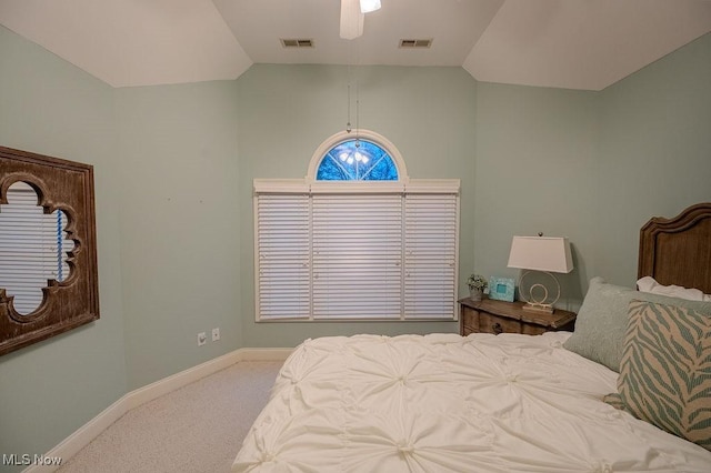 carpeted bedroom featuring baseboards, visible vents, and vaulted ceiling