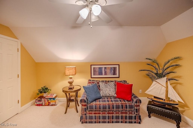 living area with vaulted ceiling, carpet, and baseboards