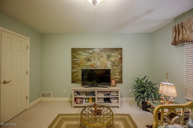 living room featuring carpet, visible vents, and baseboards