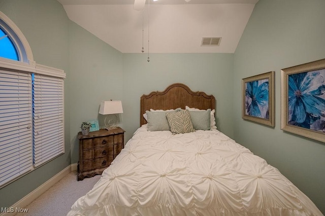 bedroom with carpet floors, lofted ceiling, visible vents, ceiling fan, and baseboards