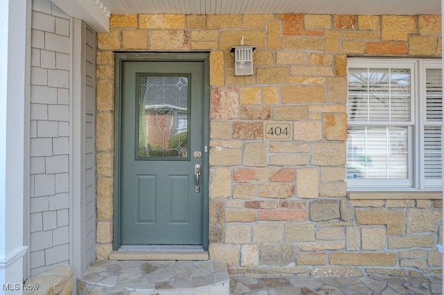 view of exterior entry featuring stone siding