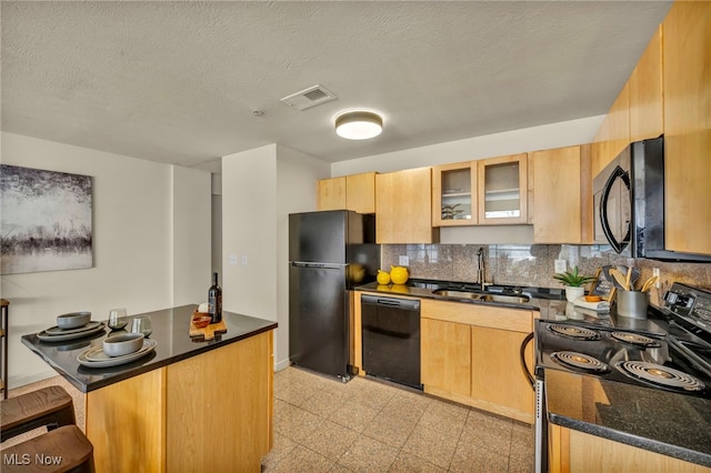 kitchen featuring sink, kitchen peninsula, a textured ceiling, decorative backsplash, and black appliances