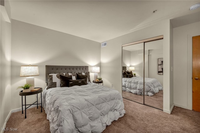 bedroom with a closet and light colored carpet