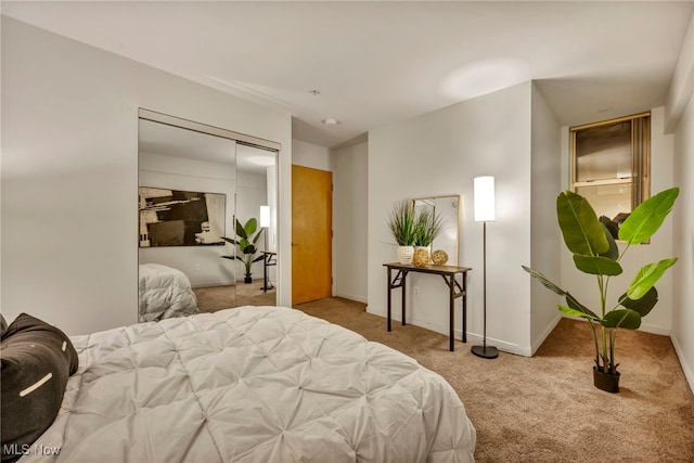 bedroom featuring light colored carpet and a closet