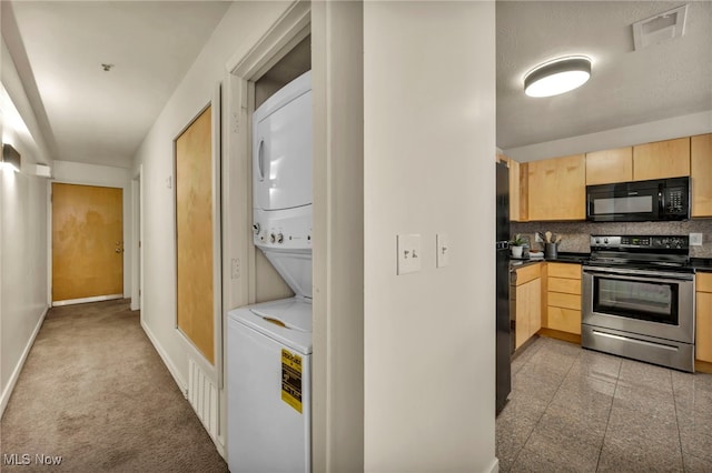 kitchen featuring light brown cabinets, backsplash, stacked washer and dryer, and black appliances