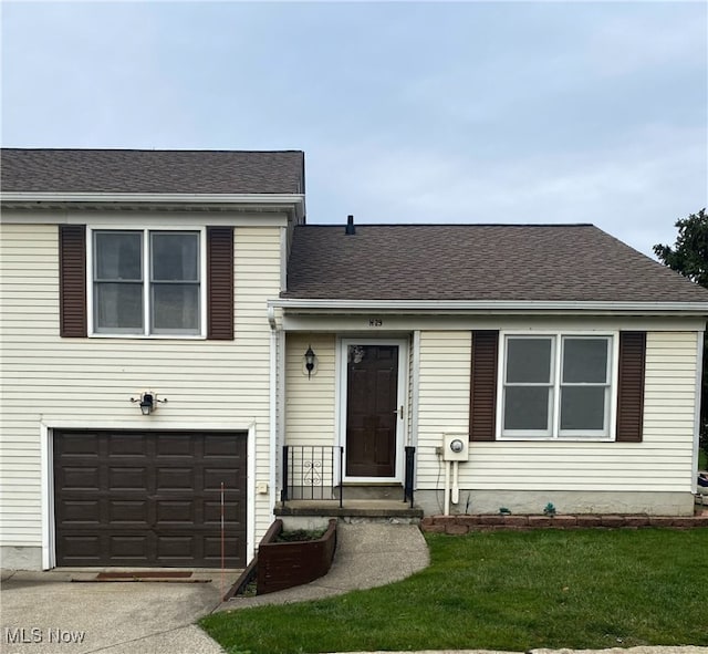 view of front of house with a garage and a front lawn