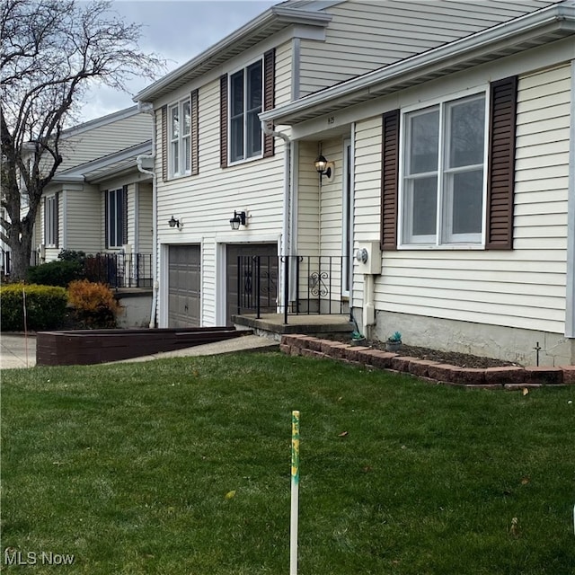 tri-level home with a front lawn and a garage