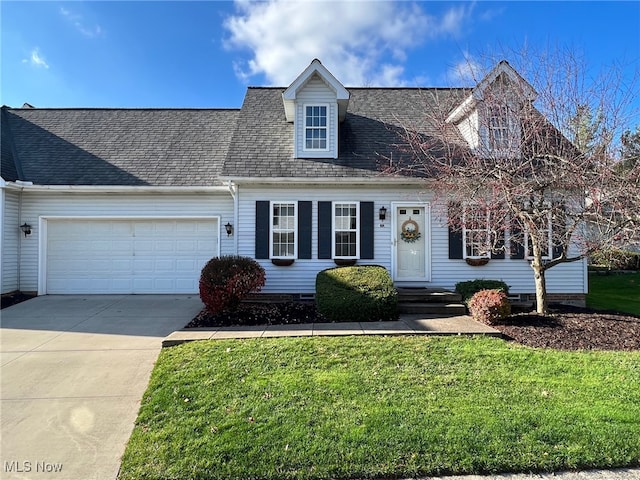 cape cod home with a garage and a front lawn