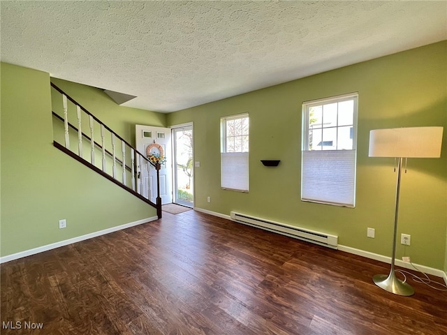 foyer entrance with dark hardwood / wood-style floors, a textured ceiling, and a baseboard radiator