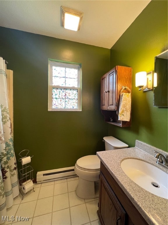 bathroom with baseboard heating, tile patterned floors, vanity, and toilet