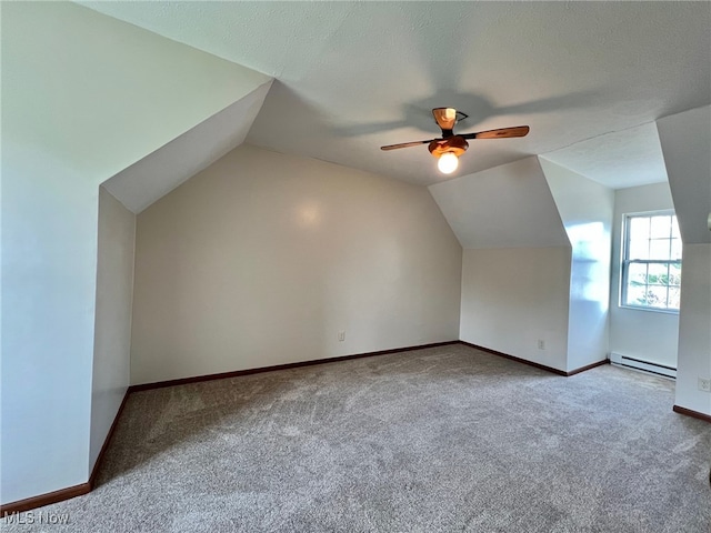 bonus room with carpet, lofted ceiling, a baseboard heating unit, ceiling fan, and a textured ceiling