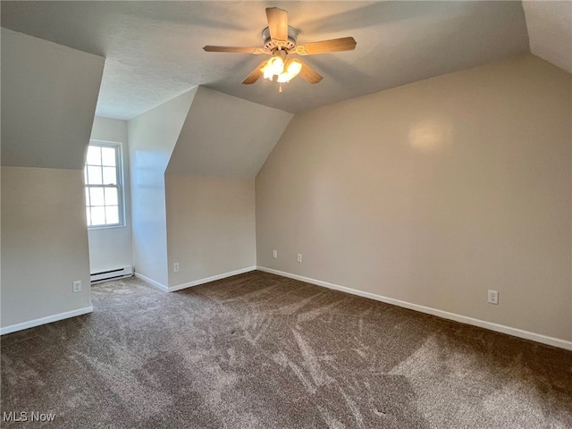 bonus room featuring ceiling fan, dark carpet, baseboard heating, and vaulted ceiling