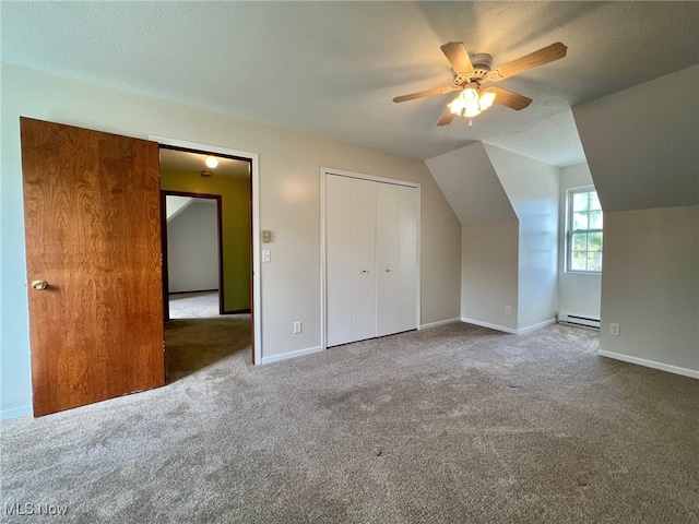 bonus room with carpet, vaulted ceiling, and a baseboard heating unit