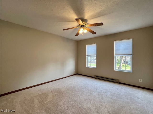 carpeted empty room with a textured ceiling, baseboard heating, and ceiling fan