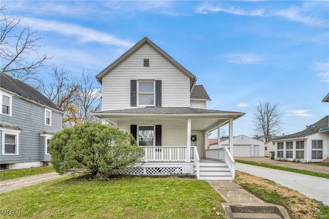 view of front of house featuring a front lawn, covered porch, and an outdoor structure