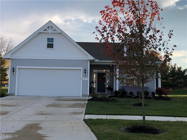 view of front of house featuring a front lawn and a garage