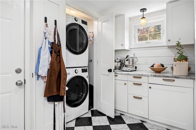 laundry area with stacked washer and clothes dryer