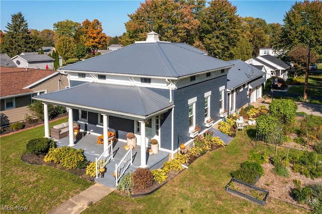 exterior space with outdoor lounge area, a front yard, and covered porch