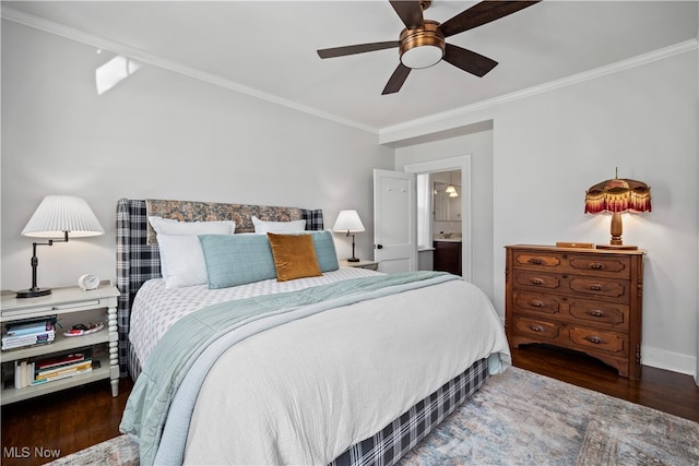 bedroom featuring dark wood-type flooring, ornamental molding, ceiling fan, and ensuite bathroom