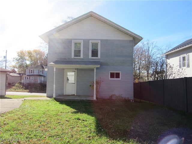 rear view of house with a yard