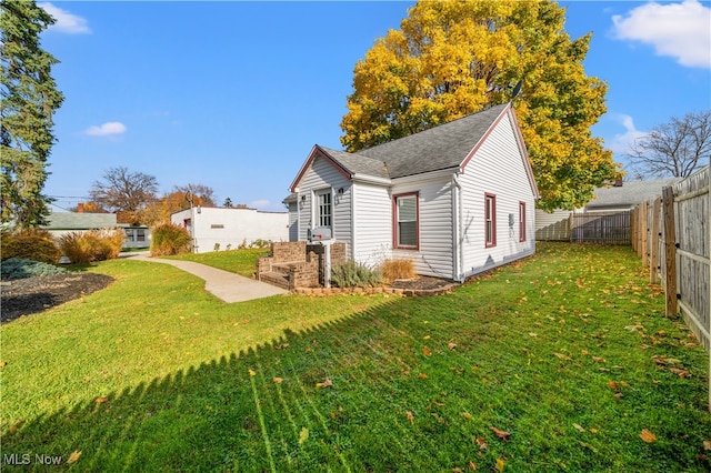 view of home's exterior with a yard