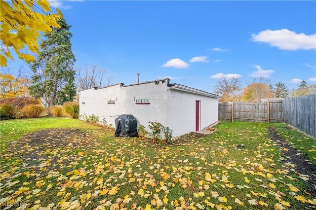 view of side of home with a lawn