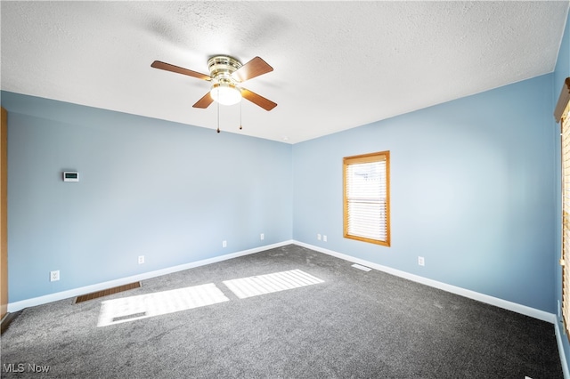 carpeted spare room featuring a textured ceiling and ceiling fan