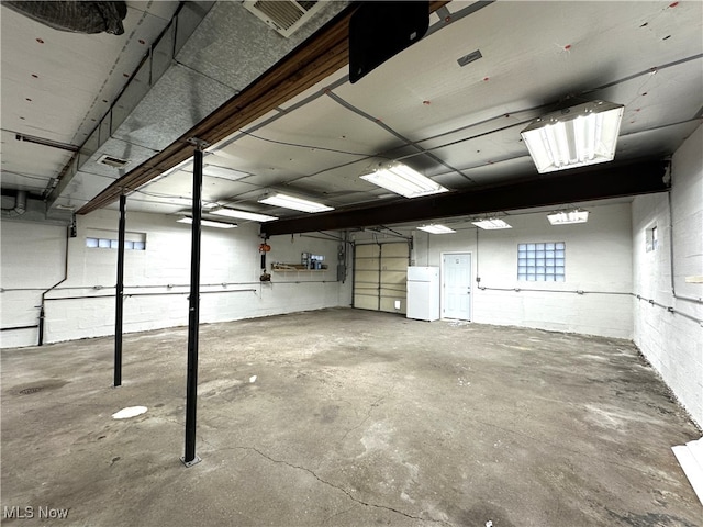 basement with white refrigerator